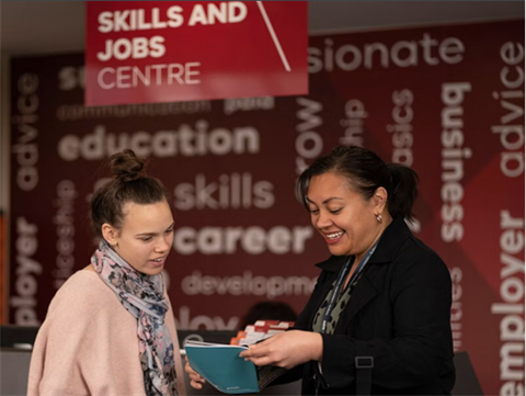 Two women reviewing career information at a Skills and Jobs Centre